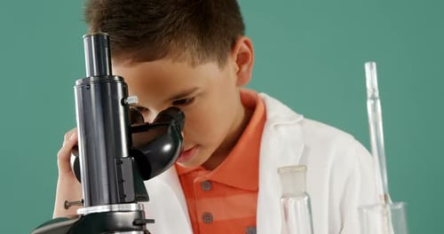 Schoolboy looking through microscope in laboratory 4k