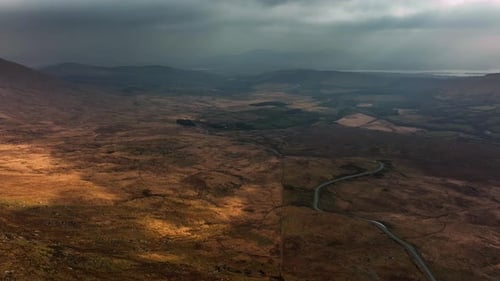 Killarney, Kerry, Ireland, March 2022. Drone pulls northwest while descending towards Molls Gap unde