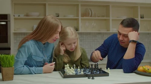 Family Playing Chess Together at Home