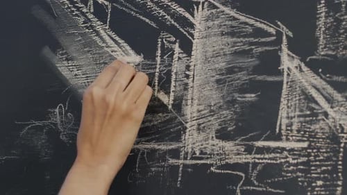 Hand Drawing Abstract Lines on a Chalkboard