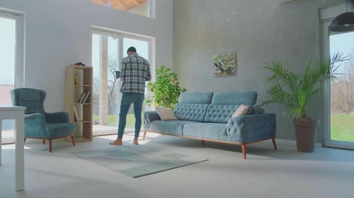 Man Works on Laptop in Modern Living Room