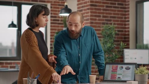 Colleagues Collaborate in Modern Office, Celebrate Success