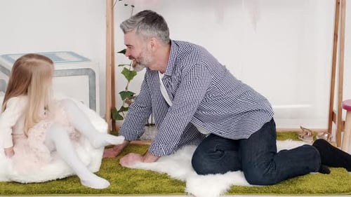 Father and Daughter Chatting Indoors