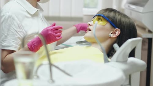 Dentist Examining a Patient's Teeth in Office