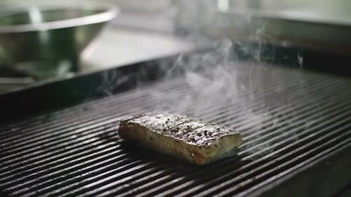 Seasoned Steak Cooking on a Sizzling Grill