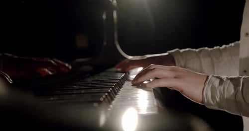 Hands Play Classical Piano Music in Dark Room