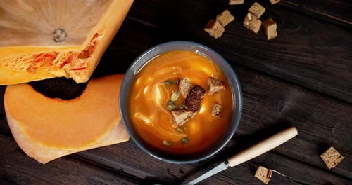 Overhead Bowl of Pumpkin Soup With Fresh Pumpkin