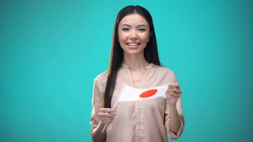 Frau bedeckt Gesicht mit japanischer Flagge, lernt Sprache, Bildung und Reisen