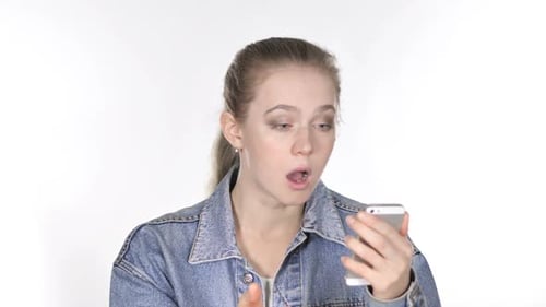 Surprised Woman Using Her Mobile Phone Indoors