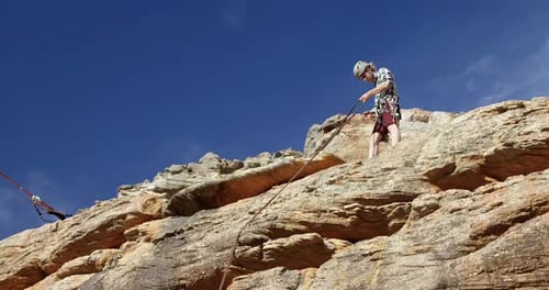 Mountaineer adjusting the rope