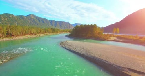 UHD Aerial View. Low Flight Over Fresh Cold Mountain River at Sunny Summer Morning. Green Trees and