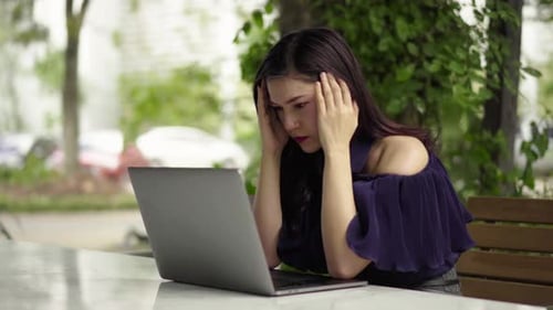 stressed woman using laptop computer