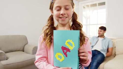 Daughter holding greeting card