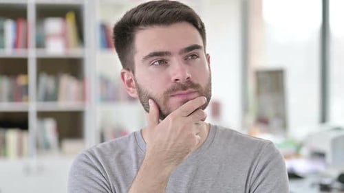 Thoughtful Man Thinking in Office Setting