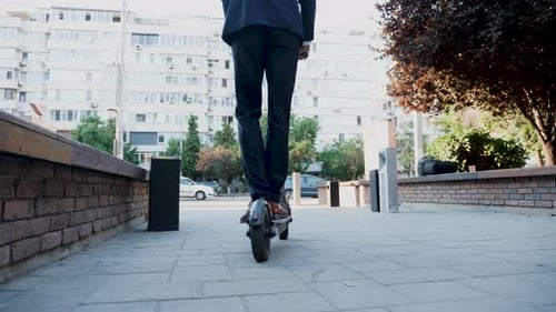 Businessman Using an Electric Scooter To Get To Work