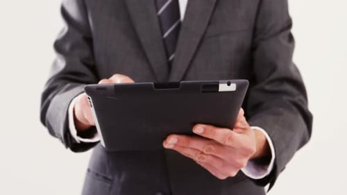 Adult Uses Tablet in Business Attire