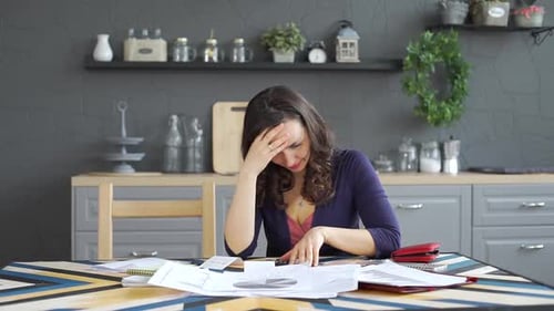 Stressed Woman Reviewing Personal Finances at Home