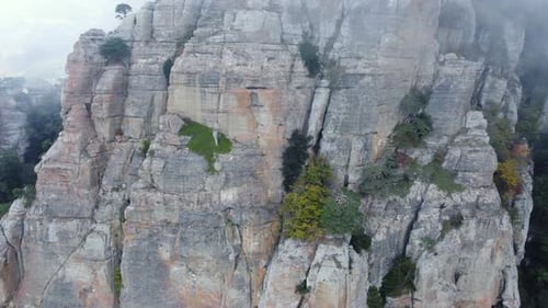 Mountains with Rocky Sculptures That are Getting Covered By Clouds