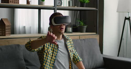 Man Experiencing Virtual Reality on Couch at Home