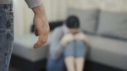 Aggressive Man with Fists, Woman Huddled on Floor
