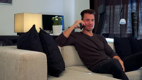 Man Relaxing on Couch Talking on Cell Phone