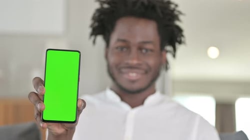Portrait of African Man Holding Smartphone with Chroma Key Screen