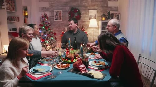 Family Celebrates Christmas with Meal and Drinks