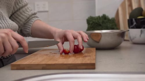 Slicing Tomatoes in Kitchen for Healthy Meal