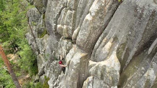 Strong Male Climber Climbing Steep Wall of Rocky Mountain