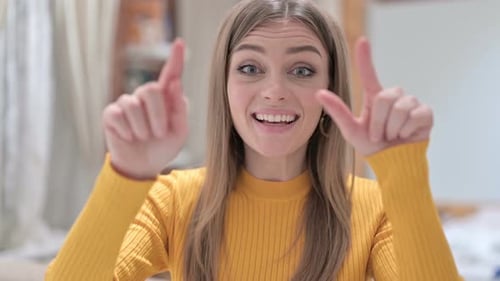 Portrait of Creative Young Woman Pointing and Inviting