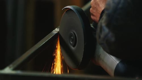 Worker Grinding Metal with Sparks Flying