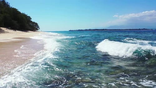 Natural above island view of a summer white paradise sand beach and blue ocean background in 4K