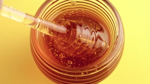 Closeup of Honey Spoon with Pouring Honey