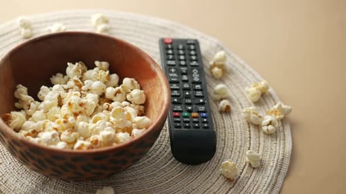 High Angle View of Popcorn and Tv Remote on Table