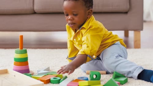 Cute Child Playing with Colorful Wooden Blocks