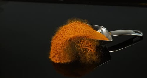 Turmeric, curcuma longa, Powder falling against Black Background, Indian Spice, Slow Motion 4K