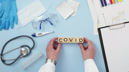 COVID Spelled Out with Medical Equipment Overhead