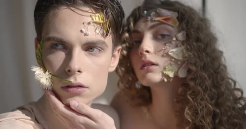 Tendet Young Couple with Floral Make Up Pose in Studio