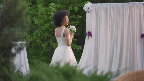Side View Portrait of Smiling Happy Young African American Bride in Beautiful Wedding Dress Looking