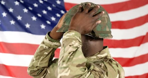 Soldier Poses in Front of American Flag
