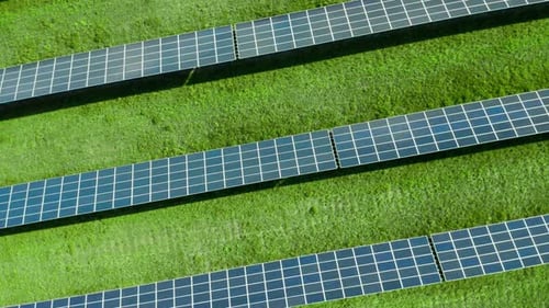 Aerial Circling Over Solar Panels on the Green Field. Photovoltaic Power Plant
