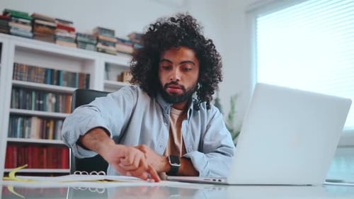 Adult Man Works at Home on Laptop