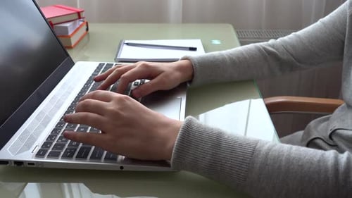 The girl working at home office hands on keyboard