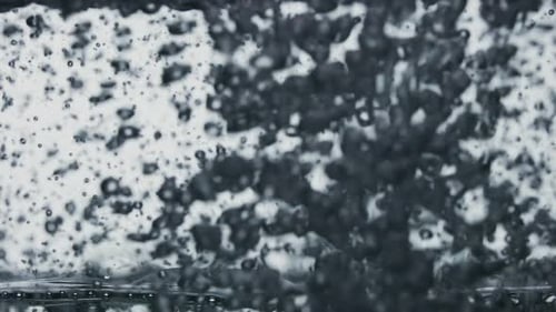 The Clear Sparkling Water is Poured Into a Transparent Glass Causing a Vortex of Oxygen Bubbles
