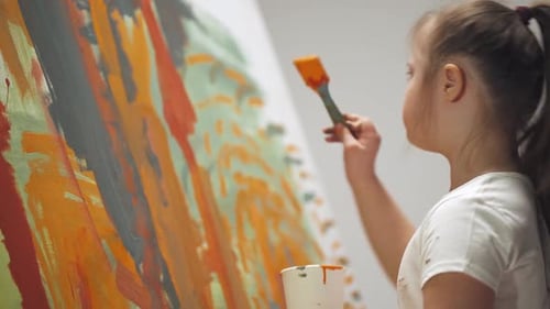 Girl Painting Abstract Art on Canvas Indoors