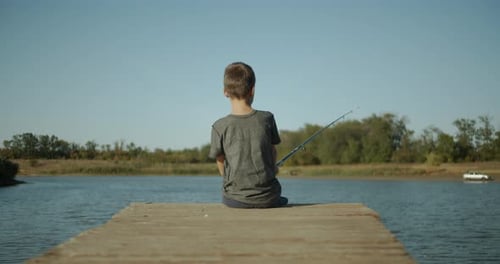A Little Boy Holding a Fishing Rod. Fishing Concept