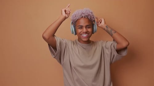 Woman with Headphones Dancing and Smiling