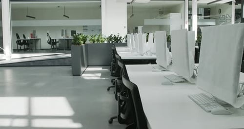 Empty Rental Office with Computers Wrapped in Cover