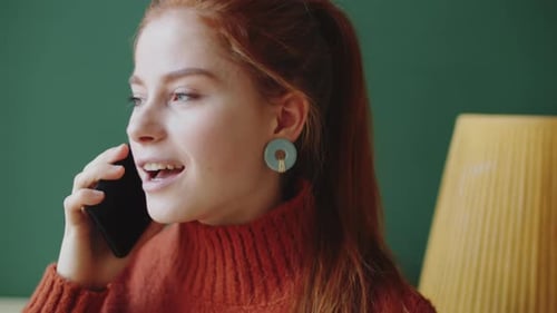 Woman with Red Hair Talking on Phone