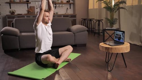 Man Doing Yoga in Modern Apartment